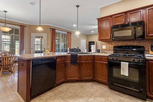 kitchen featuring a sink, black appliances, a peninsula, and light countertops