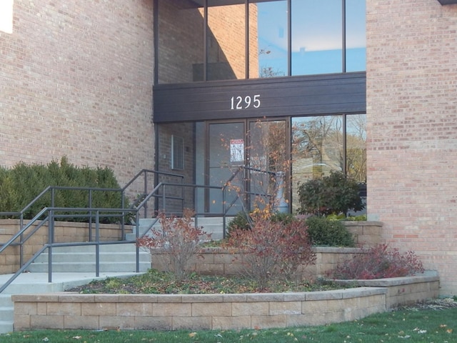 view of exterior entry with brick siding