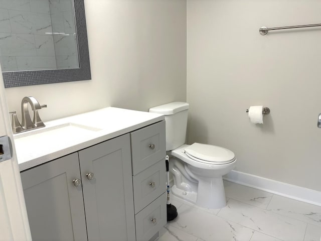 bathroom with toilet, marble finish floor, baseboards, and vanity