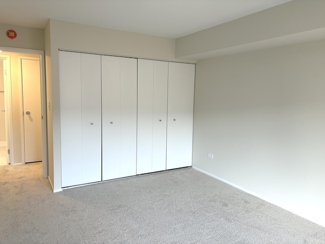 unfurnished bedroom featuring a closet and carpet flooring