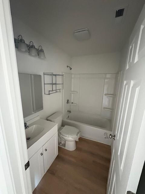 1015 Market St, Dekalb, IL 60115 - bathroom with vanity, shower / bath combination, and wood finished floors