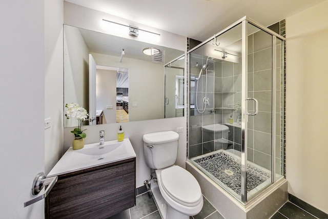 full bathroom with tile patterned floors, a stall shower, toilet, and vanity