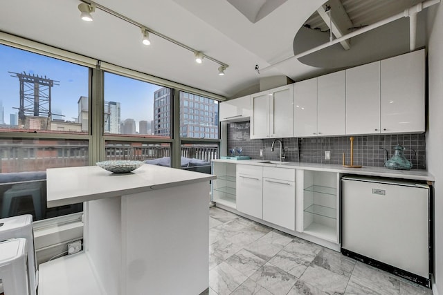 kitchen featuring a view of city, marble finish floor, a sink, fridge, and light countertops