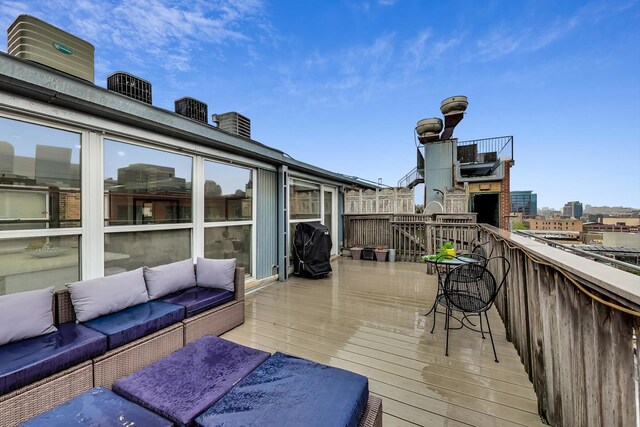 deck with outdoor lounge area and a grill