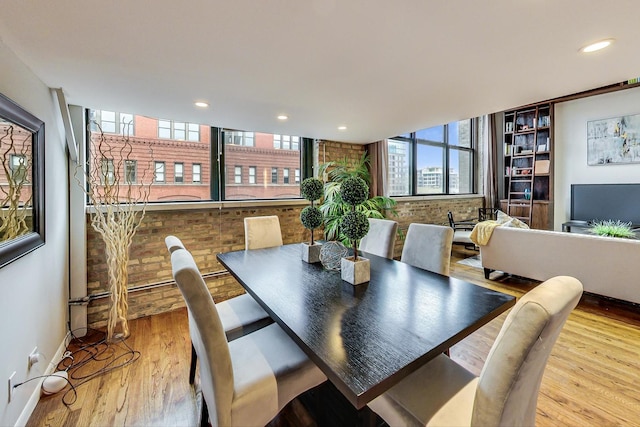 dining space featuring recessed lighting, baseboards, and wood finished floors