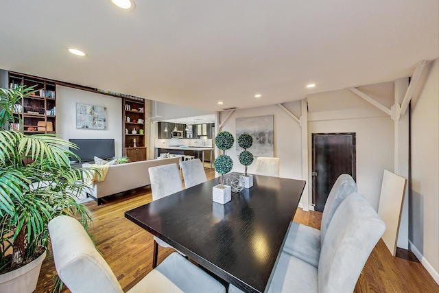 dining space featuring recessed lighting and wood finished floors