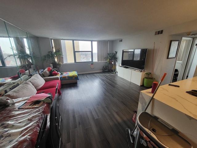 living room featuring visible vents and dark wood-style flooring