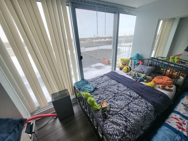 bedroom featuring access to outside and wood finished floors