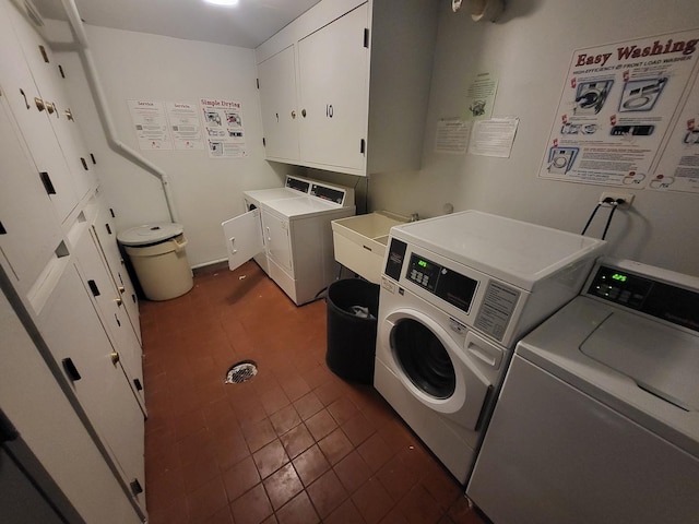laundry room with washer and dryer, cabinet space, and a sink