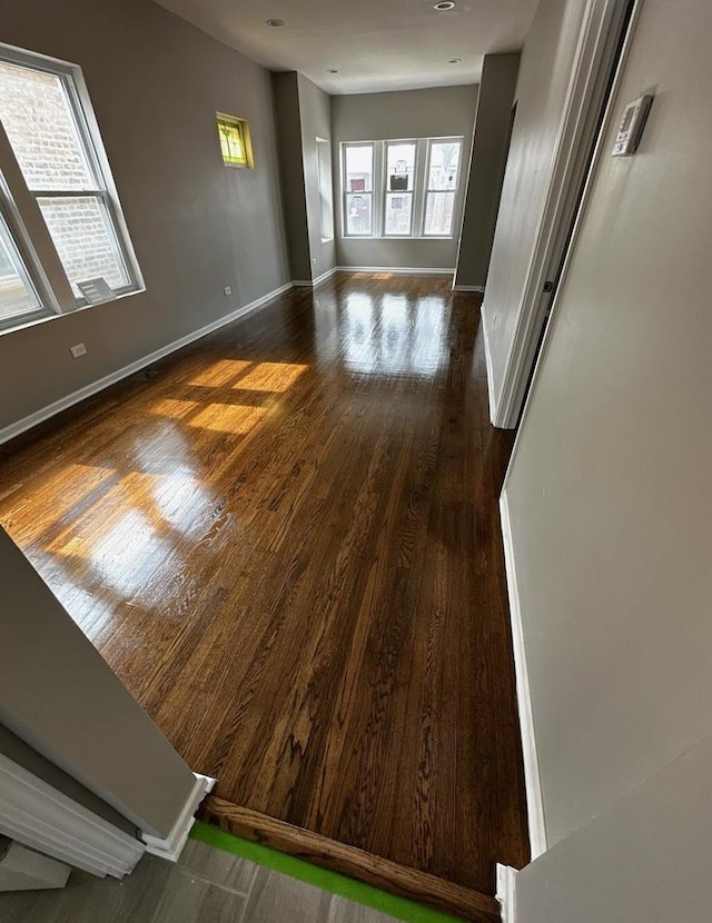 empty room featuring baseboards and wood finished floors