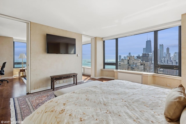 bedroom with baseboards and wood finished floors