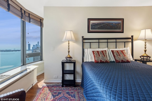 bedroom featuring baseboards and wood finished floors