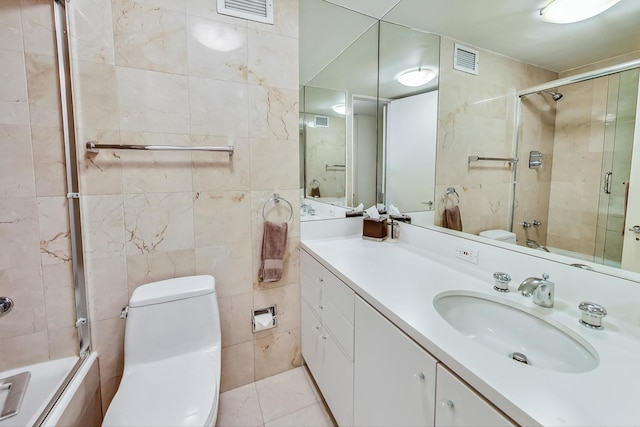 bathroom featuring visible vents, tile walls, and toilet