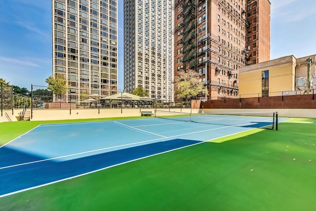 view of tennis court featuring fence