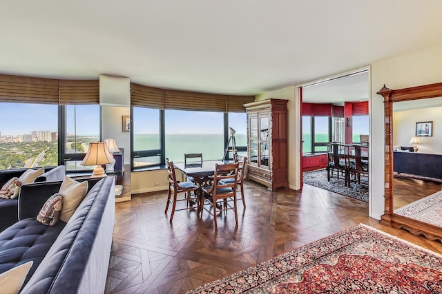 dining area with a water view, plenty of natural light, and baseboards