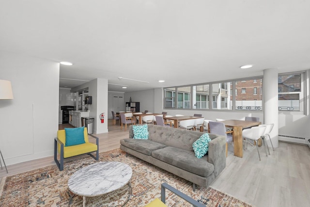 living room featuring light wood finished floors, a wealth of natural light, and recessed lighting