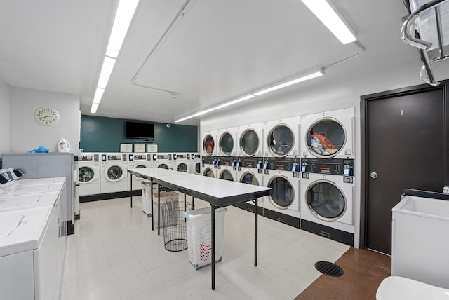 shared laundry area featuring washing machine and clothes dryer and stacked washer / drying machine