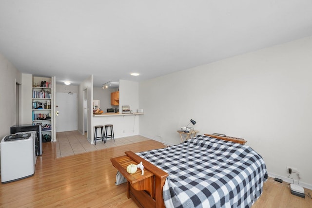 bedroom featuring light wood-type flooring and baseboards