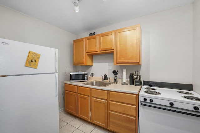 kitchen with light tile patterned floors, white appliances, a sink, visible vents, and light countertops