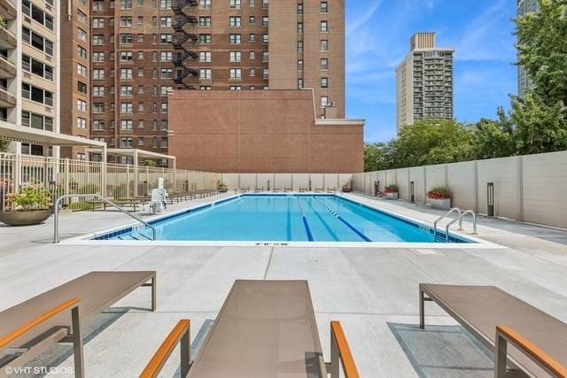 pool featuring fence and a patio