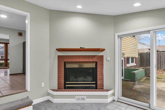 room details with recessed lighting, a brick fireplace, visible vents, and baseboards