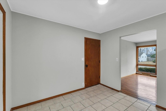 unfurnished room featuring light wood-style floors and baseboards