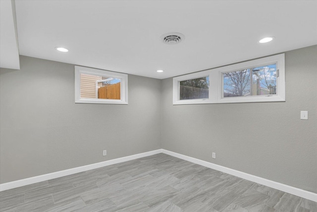 basement with recessed lighting, visible vents, and baseboards