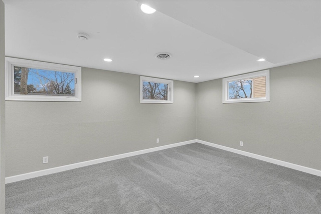 basement with carpet floors, visible vents, baseboards, and recessed lighting