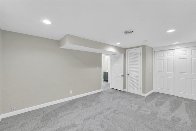 finished below grade area with recessed lighting, baseboards, visible vents, and carpet flooring