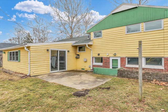 rear view of house featuring a yard and a patio area