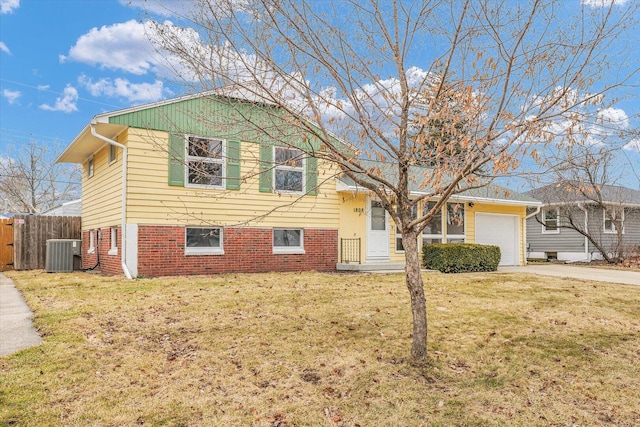 split level home with brick siding, central air condition unit, concrete driveway, a front yard, and fence