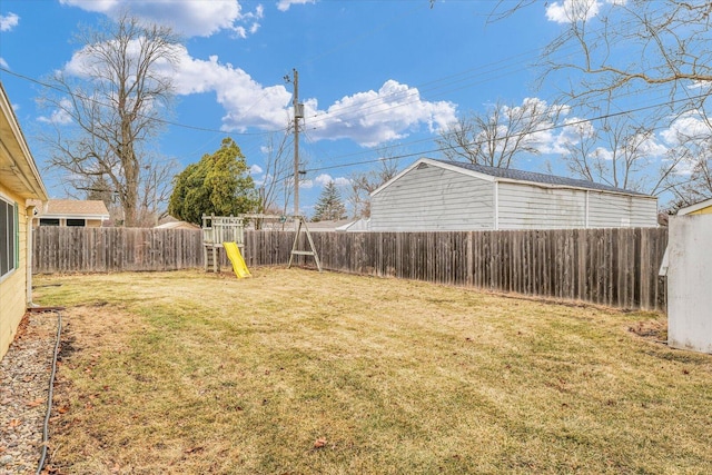 view of yard with a fenced backyard and a playground