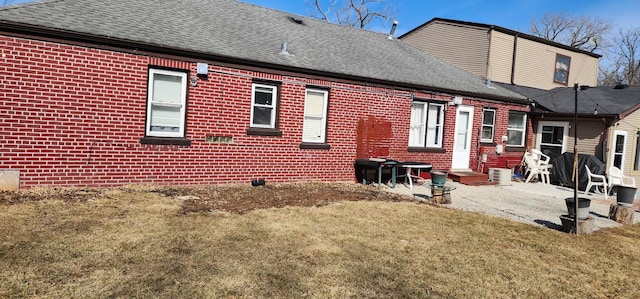 4N553 Il Route 83, Bensenville, IL 60106 - back of house featuring roof with shingles, brick siding, a lawn, a patio, and cooling unit