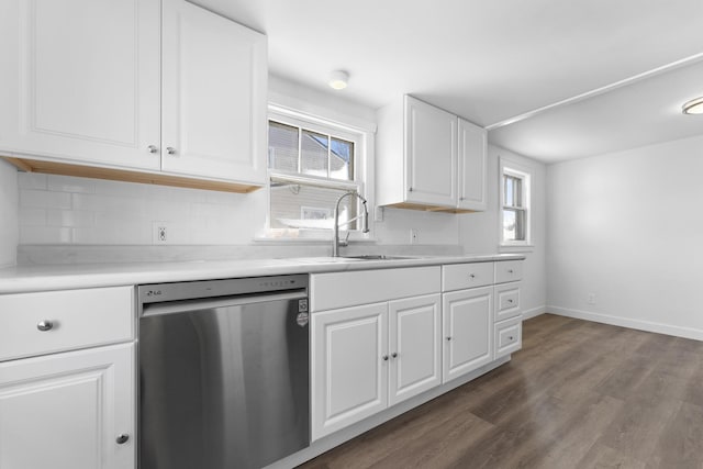 kitchen with a sink, a healthy amount of sunlight, dark wood-type flooring, and stainless steel dishwasher