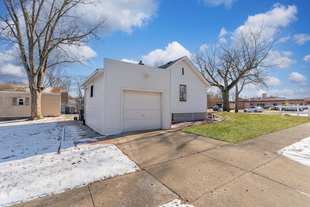 view of property exterior with a garage, a lawn, and concrete driveway