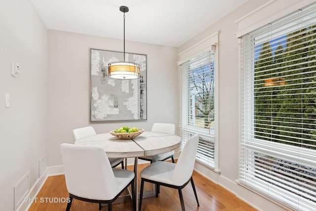 dining room featuring light wood-style floors and baseboards