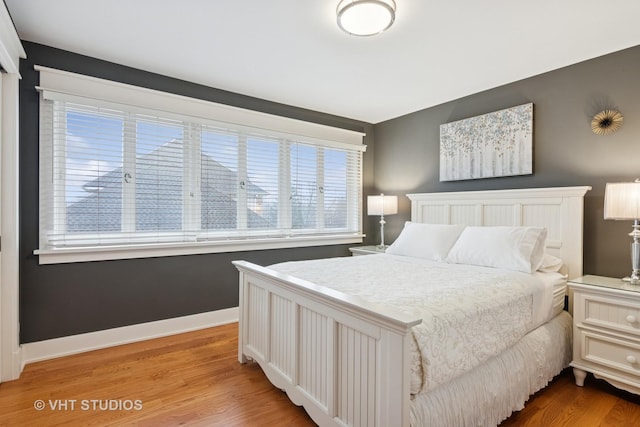 bedroom featuring light wood-type flooring and baseboards