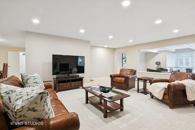 living area featuring light carpet and recessed lighting