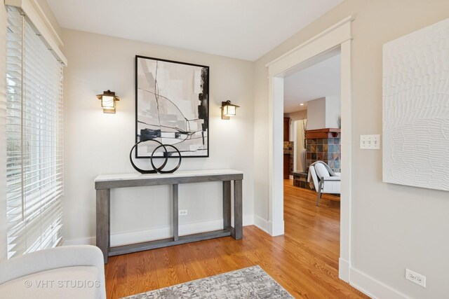 hall with baseboards and wood finished floors