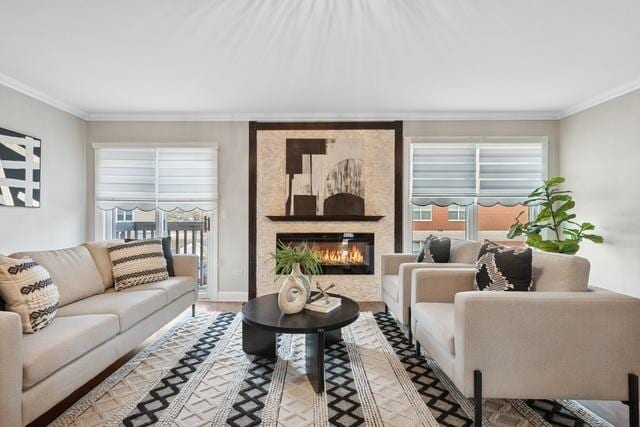 living room with ornamental molding, a wealth of natural light, and a fireplace