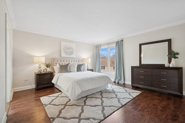 bedroom with baseboards, dark wood finished floors, and crown molding