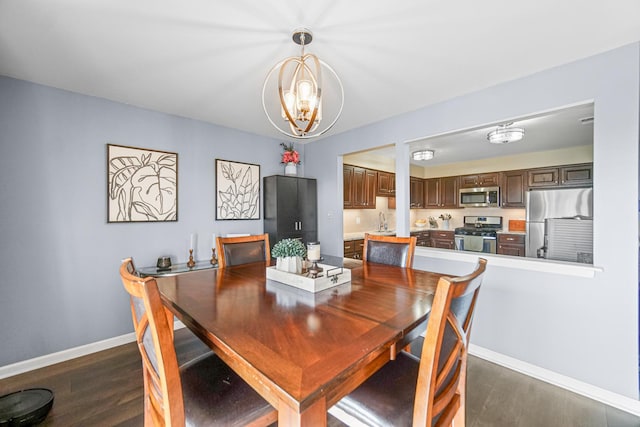 dining area with dark wood-style floors, a chandelier, and baseboards