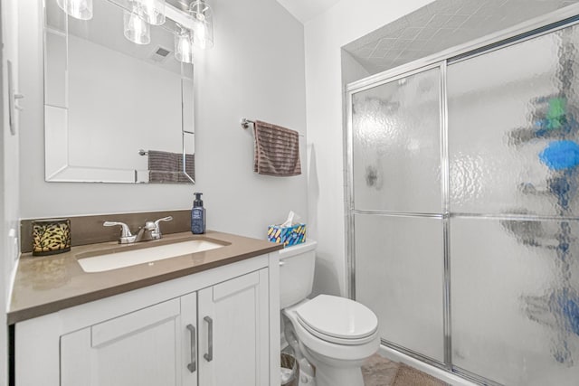 full bathroom with visible vents, toilet, a shower stall, vanity, and tile patterned floors