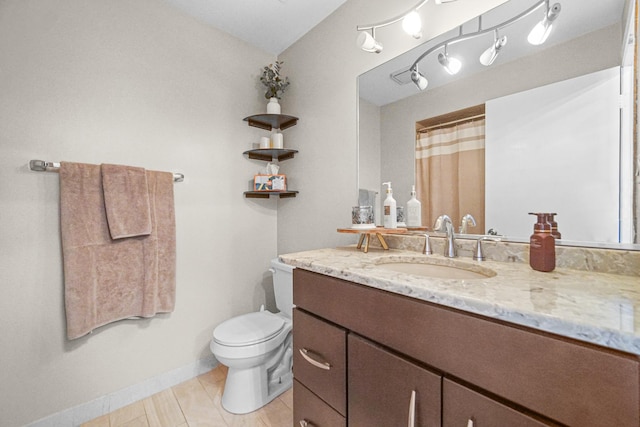 full bath with tile patterned flooring, baseboards, vanity, and toilet