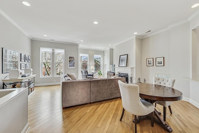 dining space featuring recessed lighting, a fireplace, light wood-style flooring, and baseboards