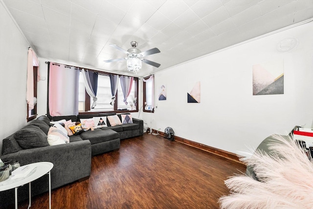 living area with ornamental molding, ceiling fan, baseboards, and wood finished floors