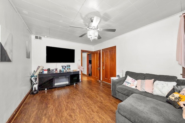 living room with baseboards, ceiling fan, visible vents, and wood finished floors