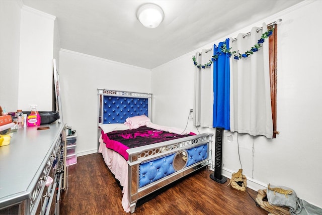 bedroom with crown molding and wood finished floors