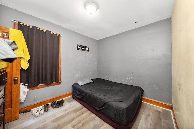 bedroom featuring baseboards and wood finished floors