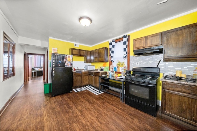 kitchen featuring ornamental molding, dark wood-style flooring, under cabinet range hood, black appliances, and backsplash